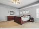 Comfortable primary bedroom with tray ceilings, plush carpet, and large dresser at 1575 Oakvista Dr, Greenwood, IN 46143