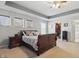 Spacious main bedroom with a tray ceiling, carpet flooring, and neutral paint at 1575 Oakvista Dr, Greenwood, IN 46143