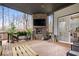 Covered back porch with outdoor fireplace and seating area at 16193 Burnt Rock Ln, Fortville, IN 46040