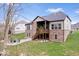 Spacious backyard featuring a patio, deck, and well-maintained lawn at 16193 Burnt Rock Ln, Fortville, IN 46040