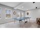 Finished basement with ping pong table and outside view at 16193 Burnt Rock Ln, Fortville, IN 46040