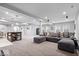 Spacious finished basement area featuring a comfortable sectional sofa and entertainment space at 16193 Burnt Rock Ln, Fortville, IN 46040