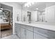 Bright bathroom featuring double vanities with gray cabinets and a glass shower at 16193 Burnt Rock Ln, Fortville, IN 46040