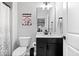 Modern half bathroom features a black vanity and commode at 16193 Burnt Rock Ln, Fortville, IN 46040