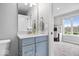 Charming bathroom with a blue vanity, granite countertop, and natural light at 16193 Burnt Rock Ln, Fortville, IN 46040