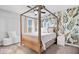 A beautiful bedroom featuring a canopy bed and leaf-patterned wallpaper at 16193 Burnt Rock Ln, Fortville, IN 46040