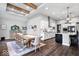 A dining room with hardwood floors, recessed lighting, beam ceilings, and a table with seating at 16193 Burnt Rock Ln, Fortville, IN 46040