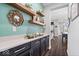 Hallway features decoratively adorned floating shelves, dark hardwood floors, a long countertop and drawers at 16193 Burnt Rock Ln, Fortville, IN 46040