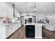 An open-concept kitchen with a large island, hardwood floors, stainless appliances, and modern light fixtures at 16193 Burnt Rock Ln, Fortville, IN 46040