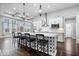 Bright kitchen featuring a large center island with bar stool seating, modern lighting and stainless-steel appliances at 16193 Burnt Rock Ln, Fortville, IN 46040
