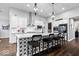 Kitchen features a large center island with bar stool seating, modern lighting, and stainless-steel appliances at 16193 Burnt Rock Ln, Fortville, IN 46040