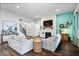 A well-lit living room with hardwood floors, a fireplace, and staircase at 16193 Burnt Rock Ln, Fortville, IN 46040