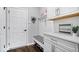 Well-organized mudroom featuring white cabinetry, bench with shoe storage, and stylish decor at 16193 Burnt Rock Ln, Fortville, IN 46040