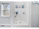 Convenient pet shower station featuring white subway tile and a handheld shower head at 16193 Burnt Rock Ln, Fortville, IN 46040