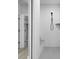 Modern shower featuring white subway tile, a black shower head, and a glass door at 16193 Burnt Rock Ln, Fortville, IN 46040