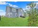 Backyard of the home with green lawn, patio furniture and siding exterior at 1691 Beyers St, Fortville, IN 46040