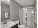 Bathroom featuring a glass shower, modern vanity and sink with great lighting at 1691 Beyers St, Fortville, IN 46040