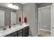 Bright bathroom with double vanity sinks, dark cabinets, and neutral wall paint at 1691 Beyers St, Fortville, IN 46040