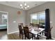 Bright dining room featuring a sliding glass door with backyard view and a modern light fixture at 1691 Beyers St, Fortville, IN 46040