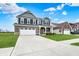 Beautiful two-story home with a well-kept lawn, a wide driveway, and charming architectural details at 1691 Beyers St, Fortville, IN 46040