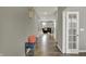 Hallway with hardwood floors, a decorative bench, and an open view into the living room at 1691 Beyers St, Fortville, IN 46040