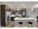 Bright kitchen with white countertop island, stainless steel appliances, and dark cabinets at 1691 Beyers St, Fortville, IN 46040