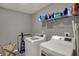 Laundry room featuring a full size washer and dryer set, wire shelving and gray walls at 1691 Beyers St, Fortville, IN 46040