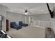 Open loft area has neutral colors, carpet, and ceiling fan at 1691 Beyers St, Fortville, IN 46040