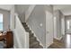 Staircase featuring carpeted steps, white railings, and easy access to the upper level at 1691 Beyers St, Fortville, IN 46040