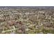 Aerial view of a neighborhood with many homes surrounded by mature trees on a sunny day at 1707 W 76Th Pl, Indianapolis, IN 46260