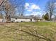 A spacious backyard showcasing a patio and plenty of greenery providing space for recreation at 1707 W 76Th Pl, Indianapolis, IN 46260