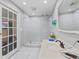 Bathroom features modern design with large sink, open shower with glass and white tile at 1707 W 76Th Pl, Indianapolis, IN 46260