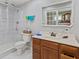 Bathroom features wood vanity, white tile flooring and shower and neutral walls at 1707 W 76Th Pl, Indianapolis, IN 46260
