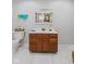 Bathroom features white tile flooring, dark wood sink and neutral walls at 1707 W 76Th Pl, Indianapolis, IN 46260