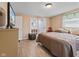 Bedroom featuring light-colored walls and trim, wood floors and a closet to bath at 1707 W 76Th Pl, Indianapolis, IN 46260