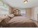 Bedroom featuring light-colored walls and trim, wood floors and a large double bed at 1707 W 76Th Pl, Indianapolis, IN 46260