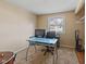 Bedroom with glass desk, carpet, and exterior view through the window at 1707 W 76Th Pl, Indianapolis, IN 46260