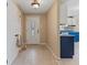 Inviting entryway with tile floors, a white door, and a glimpse of the kitchen featuring blue cabinets at 1707 W 76Th Pl, Indianapolis, IN 46260