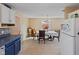 Kitchen and dining area with view of the refrigerator and dining table at 1707 W 76Th Pl, Indianapolis, IN 46260