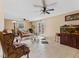 Cozy living room with tile flooring, neutral walls, ceiling fans, and a glass coffee table at 1707 W 76Th Pl, Indianapolis, IN 46260
