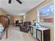 View of the living room with beige tile flooring and natural light from the windows at 1707 W 76Th Pl, Indianapolis, IN 46260