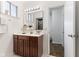 Bright bathroom featuring a vanity with a large mirror, stylish fixtures, and clean design at 1708 Fox Hill Dr, Indianapolis, IN 46228