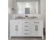 Modern bathroom with double sinks, a marble countertop, and sleek gray hardware at 1708 Fox Hill Dr, Indianapolis, IN 46228