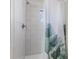 Bathroom with tiled walls and floors, along with a shower featuring a decorative shower curtain at 1708 Fox Hill Dr, Indianapolis, IN 46228