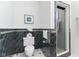 Modern bathroom with luxurious black marble walls, sleek fixtures, and a glass-enclosed shower at 1708 Fox Hill Dr, Indianapolis, IN 46228