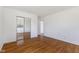 Bright bedroom features wood floors and mirrored closet doors at 1708 Fox Hill Dr, Indianapolis, IN 46228