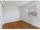 Cozy bedroom with hardwood floors, a closet, and a window providing ample natural light at 1708 Fox Hill Dr, Indianapolis, IN 46228
