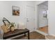 Inviting entryway with a decorative bench, floral arrangement, and a painting adding charm to the home at 1708 Fox Hill Dr, Indianapolis, IN 46228