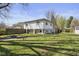 View of the home's exterior and large yard featuring a fire pit and a shed at 1708 Fox Hill Dr, Indianapolis, IN 46228
