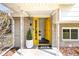 Welcoming front entrance features a bright yellow door and a modern stone facade at 1708 Fox Hill Dr, Indianapolis, IN 46228